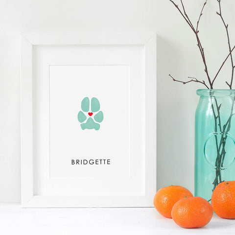 dog paw print in white frame with decorated scene of oranges and vase