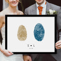 bride and groom holding framed fingerprint wedding art