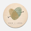 green and gold fingerprint heart printed on a round wooden sign with couples personalization