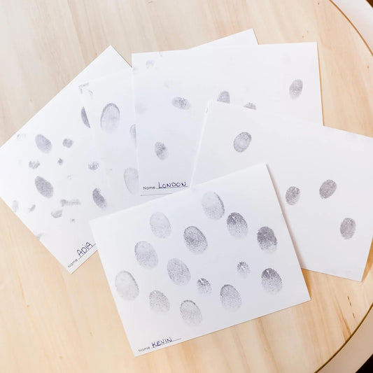 paper cards filled with family fingerprints