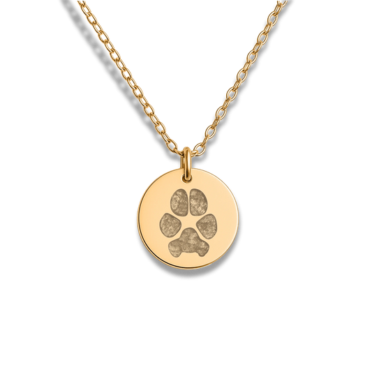 Gold necklace with a round pendant featuring an engraved paws printing. The simple, elegant design conveys warmth and affection, ideal for pet memorial gift.