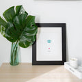 teal dog nose print pet loss memorial on table next to leaves in vase