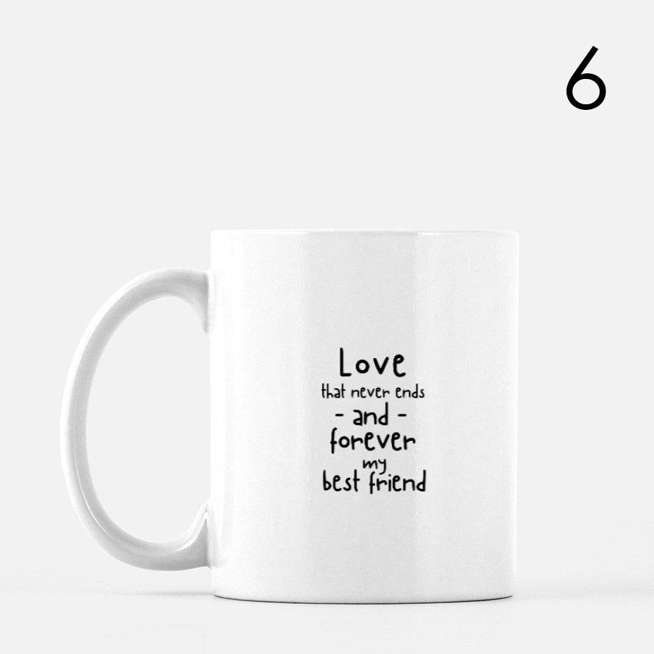 White ceramic mug featuring the black handwritten text 