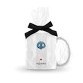 white mug with blue dog nose print and pet name wrapped in clear cellophane tied with a black ribbon