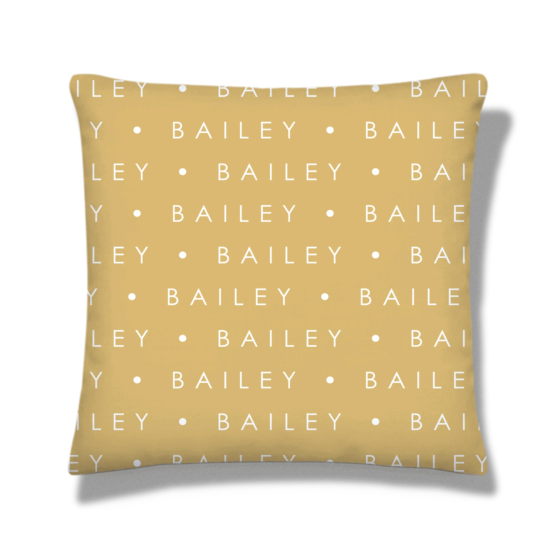 Tan pillow featuring a white dog paw print design with a small heart and in the center, above the name 