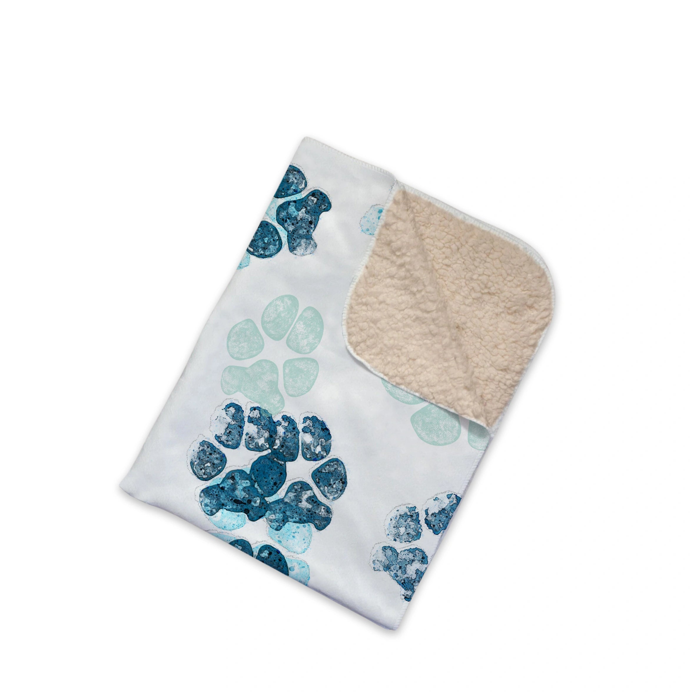 Soft blanket with a pattern of blue pet paw prints on a white background. The corner is folded to reveal a plush, beige lining, conveying warmth and comfort.