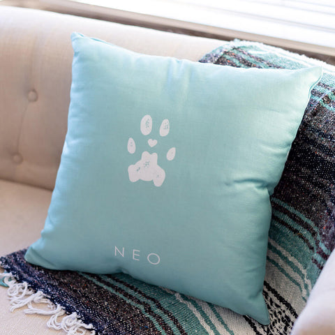 light blue pillow with printed cat paw print and name