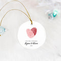 red and pink fingerprint heart our first christmas ceramic ornament on white fur background
