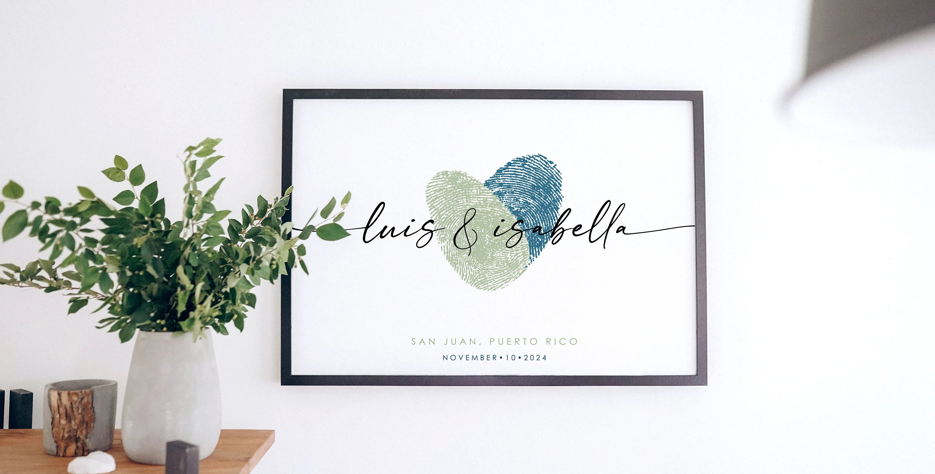 Framed wedding print featuring overlapping green and blue fingerprints forming a heart, with 