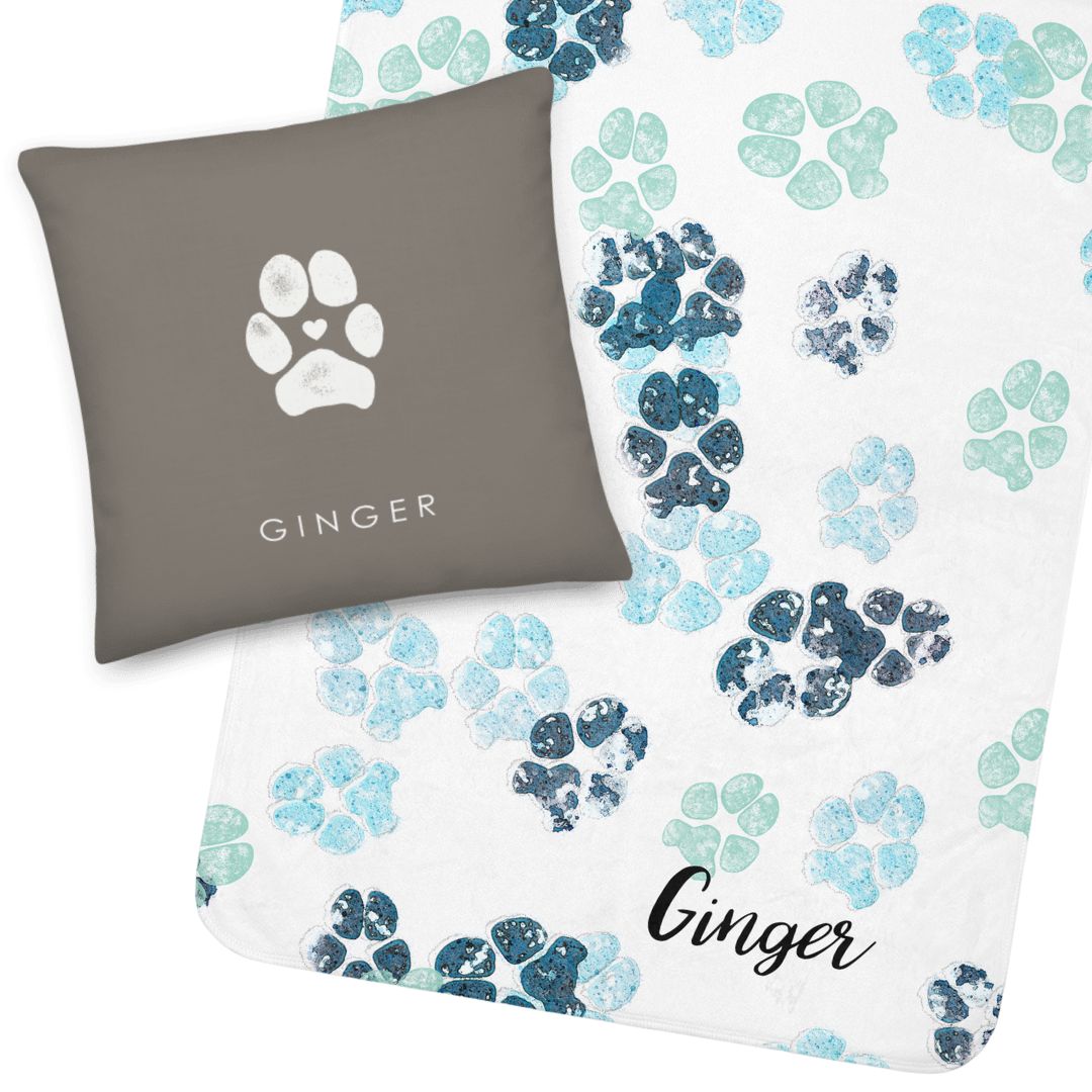 Dog paw print on grey pillow with dog paw prints multi-colored blue on blanket