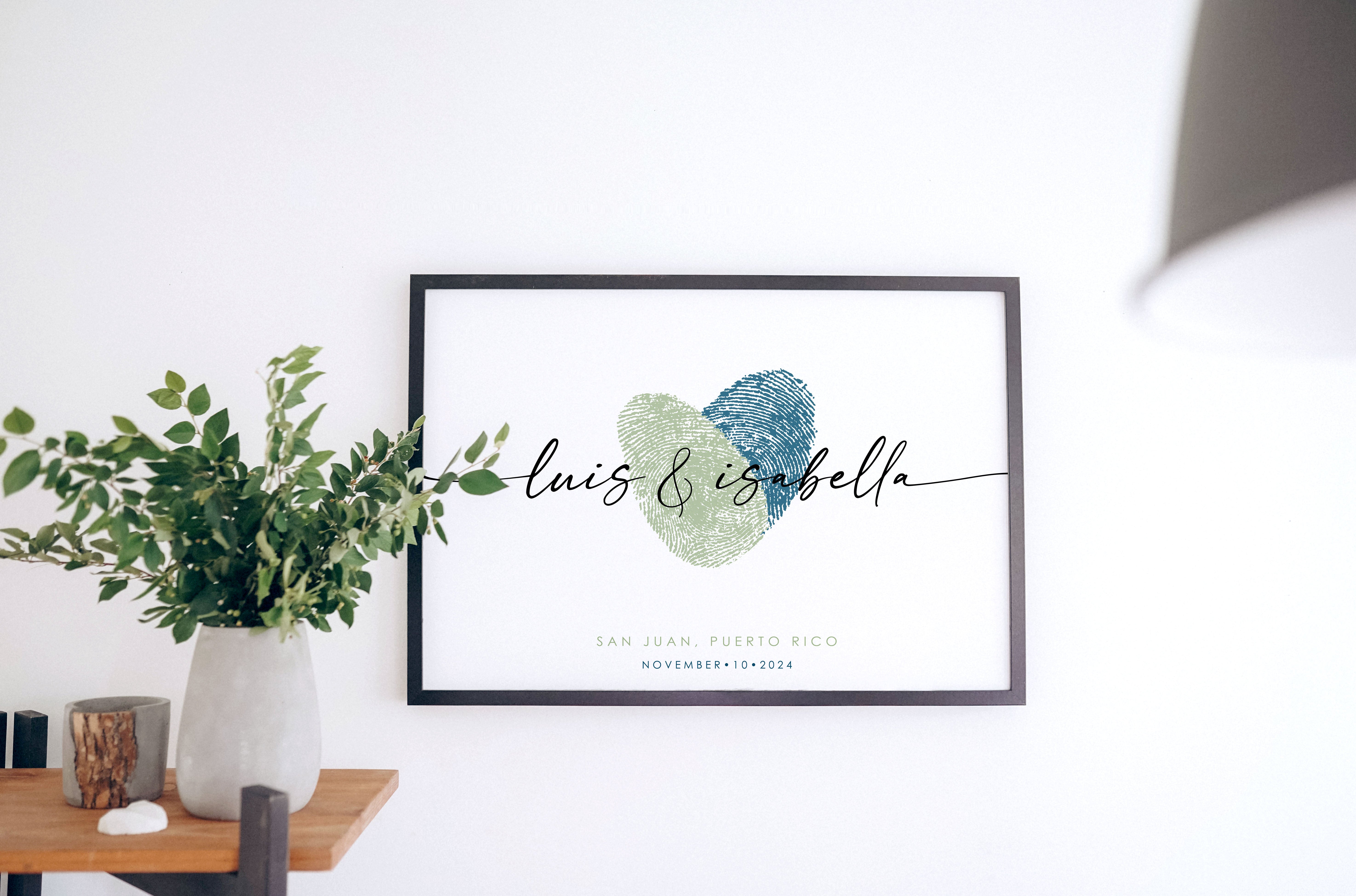 Blue and green couples fingerprint heart artwork hung on wall