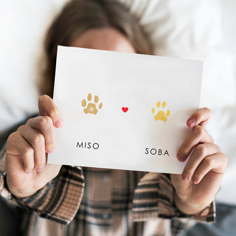 Girl holding photo Paw print memorial display for two cats 