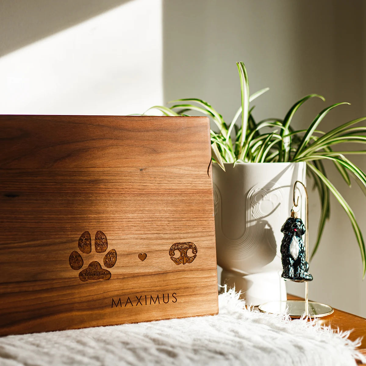 Wooden cutting board engraved with a dog paw, heart, nose, and 