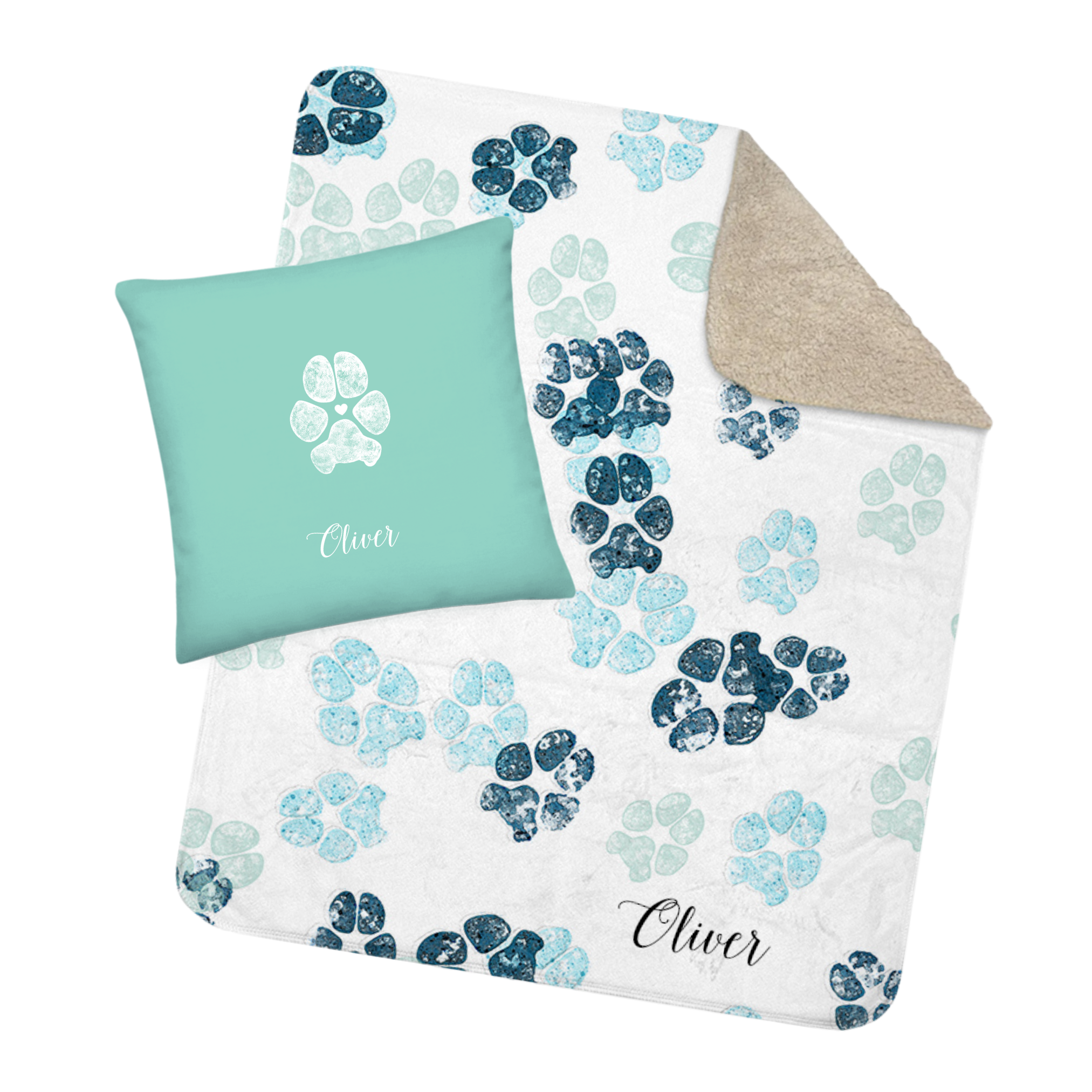 A cozy blanket and pillow set featuring blue and green dog paw prints on a white background. The pillow is turquoise with a white dog paw print and the name "Oliver."
