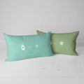 blue pillow with cat paw and nose prints and green throw pillow with dog prints