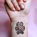 dog paw print tattoo artwork idea on women's wrist