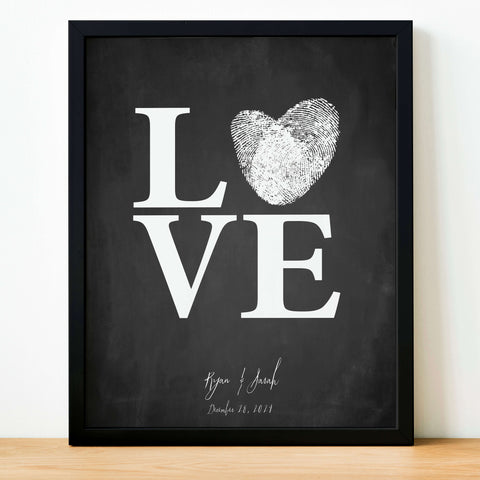 creative wedding guest book with printed chalkboard look in black and the word love in white personalized with couple's details and reception date