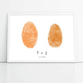 two orange fingerprints side by side in white frame with couple's initials and wedding date