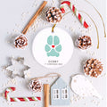Holiday scene with dog paw ornament with heart and paw print shown in aqua 