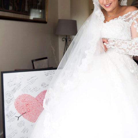 Fingerprint guest book alternative behind bride in wedding gown